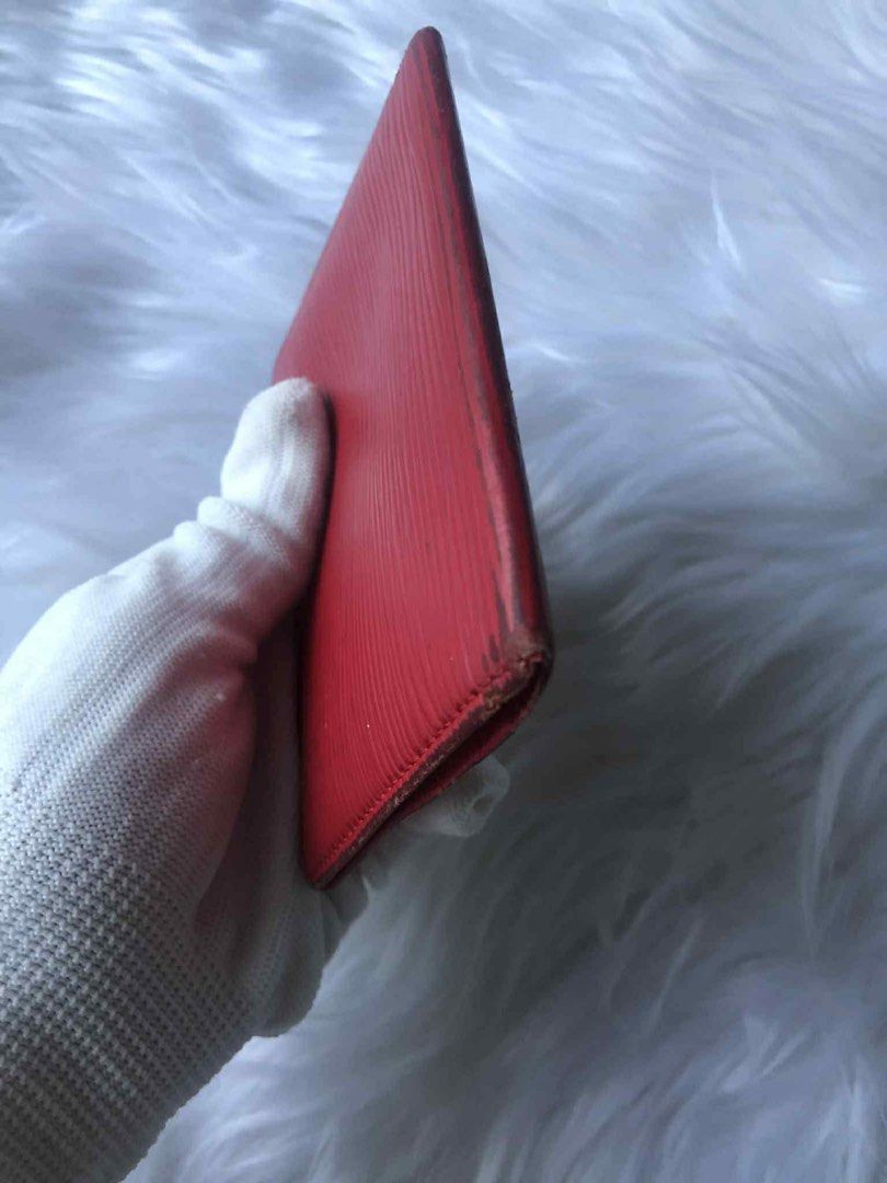 Louis Vuitton Epi Red Card Holder (Category: Luxury Bags & Wallets) located in Tarlac. Submitted by tokaidostoreexpress2 (Listing ID 1468644415, Image 3). Description: - Authentic Louis Vuitton card holder in vibrant red Epi leather - Distinct textured grain all over with subtle monogram initials stamped on the front corner - Slim profile designed to easily fit in pockets or small bags - Condition: Noticeable wear and rubbing on edges and corners
