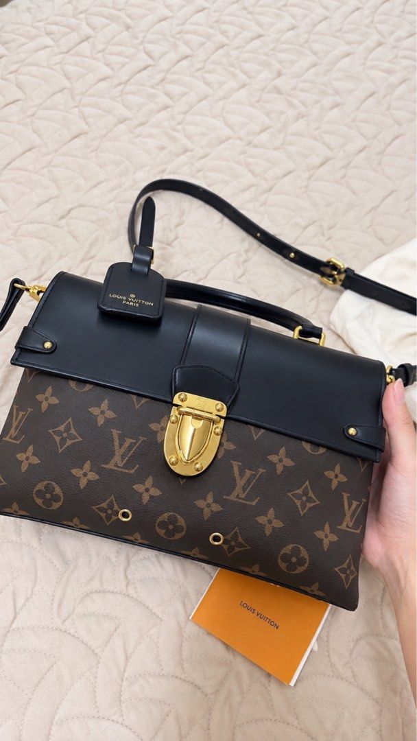 Louis Vuitton Monogram Black Leather Handbag (Category: Luxury Bags & Wallets) located in Makati City. Submitted by jianciee (Listing ID 1468569968, Image 2). Description: - Brand: Louis Vuitton - Material: Monogram canvas and smooth black leather - Hardware: Gold-tone front closure and embossed branding - Versatility: Includes a top handle and adjustable shoulder strap - Inclusions: Attached luggage tag, dust bag, and product booklet - Condition