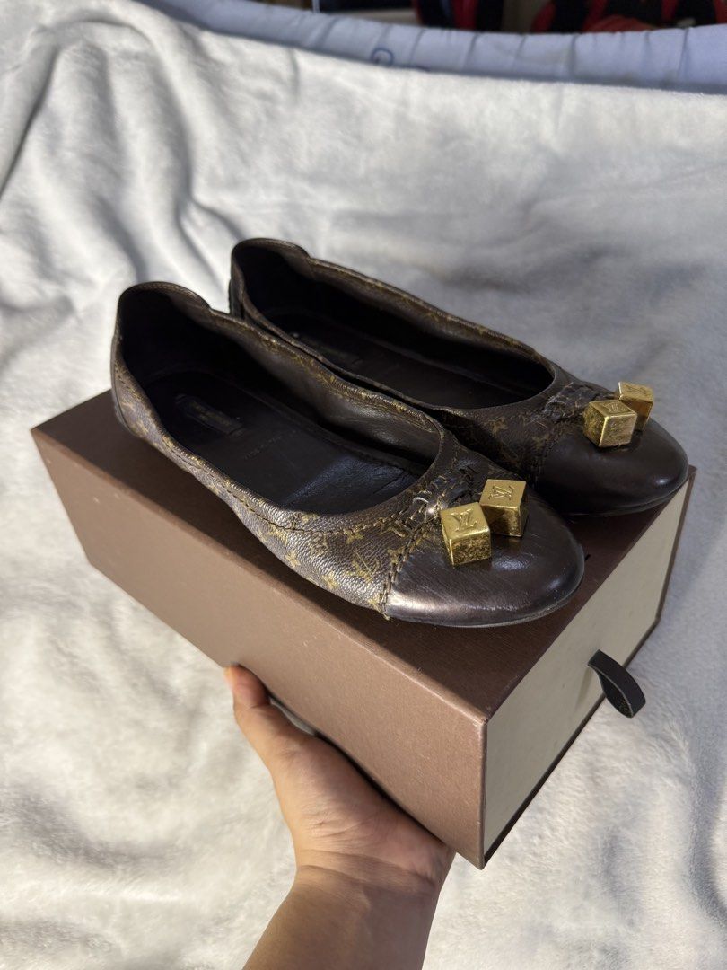 Louis Vuitton Monogram Canvas Cube Charm Ballet Flats (Category: Sneakers & Footwear) located in Manila. Submitted by yuwiii (Listing ID 1468506864, Image 1). Description: - Authentic Louis Vuitton monogram canvas ballet flats in classic brown - Made in Italy with premium dark leather trim and comfortable insoles - Features cute and elegant gold-tone dangling cube charms on the toe caps - Includes the original designer box - Perfect for effortles
