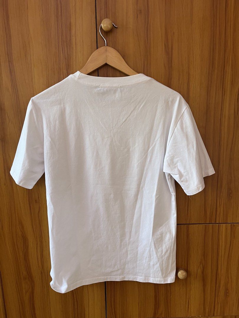 Louis Vuitton Multi Patchwork Logo White T-Shirt (Category: Shirts) located in Manila. Submitted by christian048 (Listing ID 1468649417, Image 3). Description: - Size: Large - Color: White - Material: Comfortable cotton - Design: Classic crew neck with multiple black graphic logo patches on the chest - Back: Clean with no prints - Condition: Clean, wash tag with care instructions included - Dimes: Width - 19 - Length - 25 - unnoticeable washable 