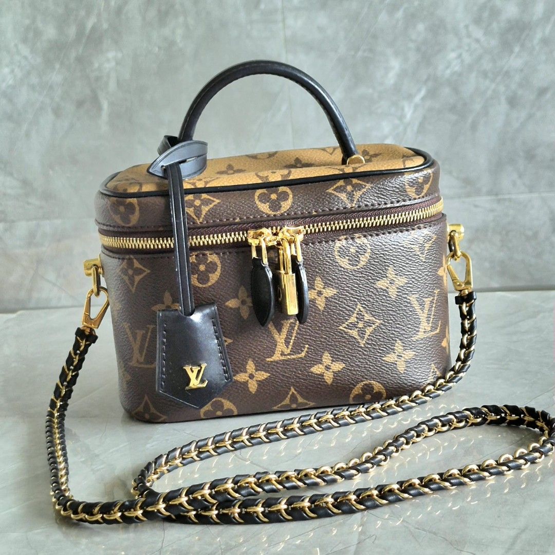 Louis Vuitton Vanity PM Monogram Reverse Canvas (Category: Luxury Bags & Wallets) located in Manila. Submitted by cara.ser (Listing ID 1468711109, Image 1). Description: Louis Vuitton vanity bag in monogram canvas. Classic brown and reverse color combination. Structured rectangular shape with a top handle and a detachable leather-and-chain shoulder strap. Gold-tone hardware throughout, including double zippers with a padlock and a key bell tag. F