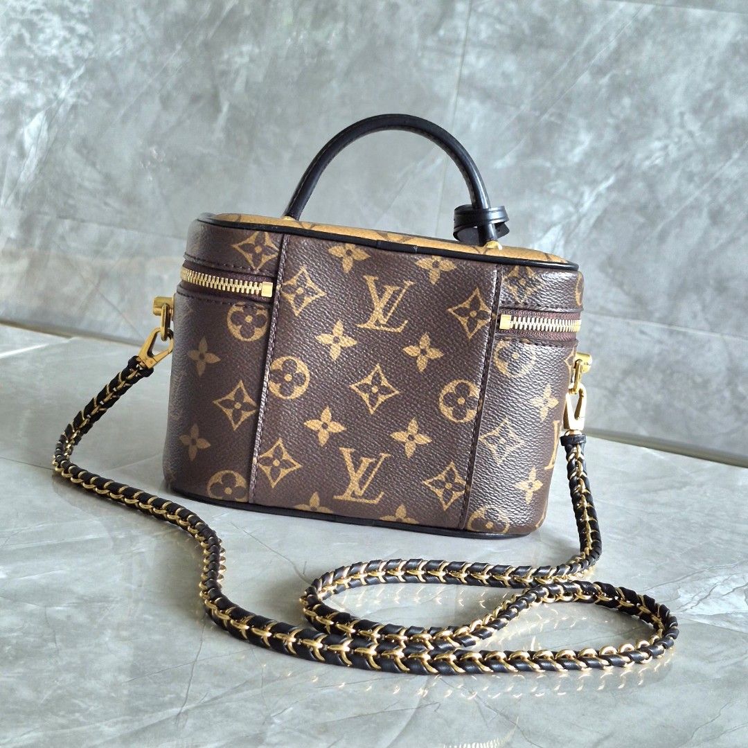 Louis Vuitton Vanity PM Monogram Reverse Canvas (Category: Luxury Bags & Wallets) located in Manila. Submitted by cara.ser (Listing ID 1468711109, Image 2). Description: Louis Vuitton vanity bag in monogram canvas. Classic brown and reverse color combination. Structured rectangular shape with a top handle and a detachable leather-and-chain shoulder strap. Gold-tone hardware throughout, including double zippers with a padlock and a key bell tag. F