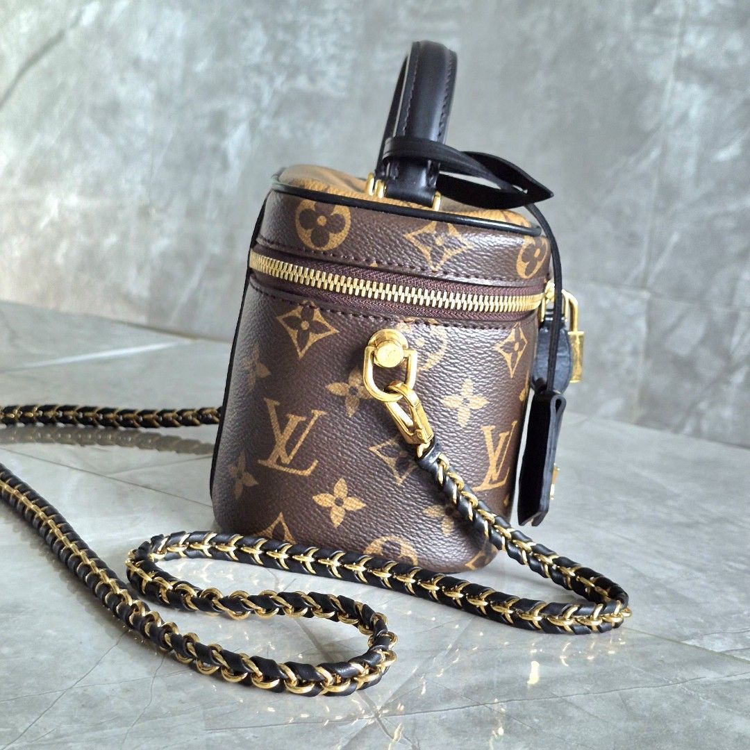 Louis Vuitton Vanity PM Monogram Reverse Canvas (Category: Luxury Bags & Wallets) located in Manila. Submitted by cara.ser (Listing ID 1468711109, Image 3). Description: Louis Vuitton vanity bag in monogram canvas. Classic brown and reverse color combination. Structured rectangular shape with a top handle and a detachable leather-and-chain shoulder strap. Gold-tone hardware throughout, including double zippers with a padlock and a key bell tag. F