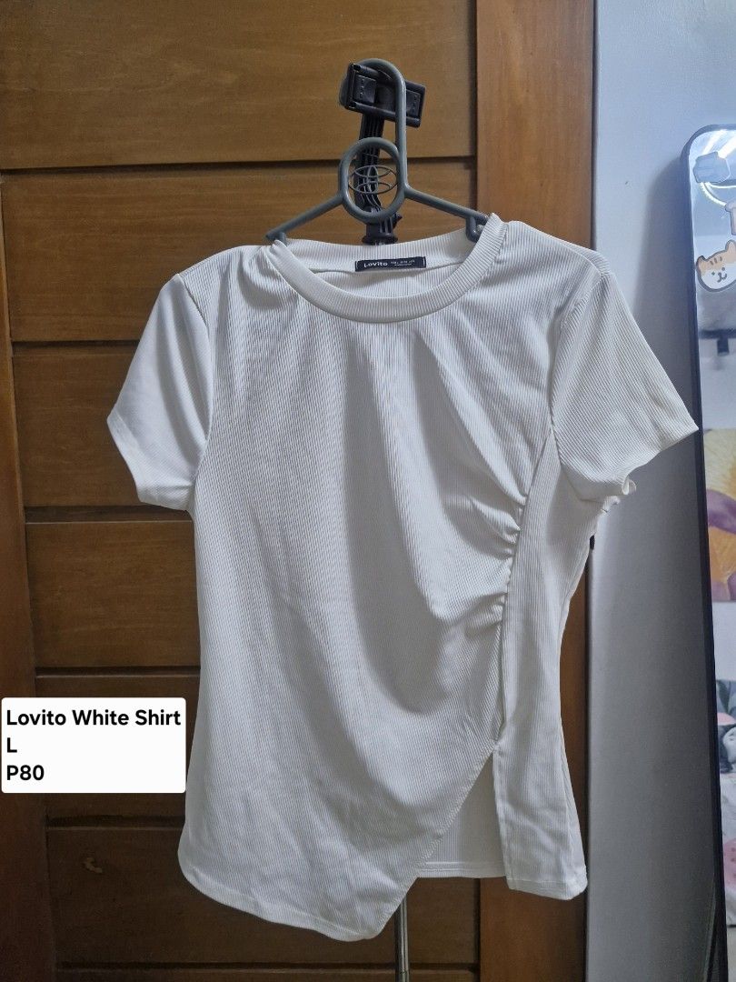 Lovito White Ribbed Shirt Size L (Category: Shirts) located in Manila. Submitted by rein.beyaa (Listing ID 1468712223, Image 1). Description: - Brand: Lovito - Color: Clean White - Size: Large - Material: Stretchy and super comfortable fabric - Design: Short sleeves, crew neckline, unique asymmetrical front hem, and side slit detail - Style: Perfect for casual daily wear, easy to match with jeans or skirts.