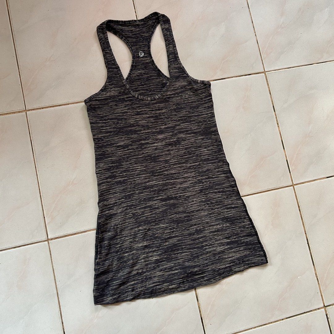Lululemon Athletic Tank Top 🥰 (Category: Sleeveless) located in Jinoba-an. Submitted by eegiboy (Listing ID 1468536224, Image 2). Description: - Brand: Lululemon - Design: Black & grey space dye pattern with scoop neckline and classic racerback - Details: Signature silver reflective logo at the upper back - Material: Soft, stretchy, and breathable fabric - Versatility: Ideal for yoga, gym workouts, or daily casual styling - Condition: Excellent 
