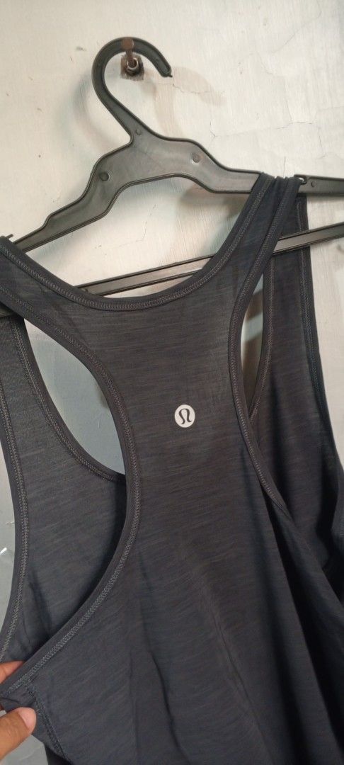 Lululemon Athletic Tank Top Grey Size 8 (Category: Sleeveless) located in Manila. Submitted by ezekislacl02490 (Listing ID 1468588820, Image 3). Description: - Brand: lululemon athletica - Color: Dark grey heathered - Size: 8 - Style: Racerback with curved hem - Details: Small reflective lululemon logo on upper back - Fabric: Lightweight and breathable - Ideal for: Workouts, running, or casual everyday wear - Condition: Great pre-loved condition.