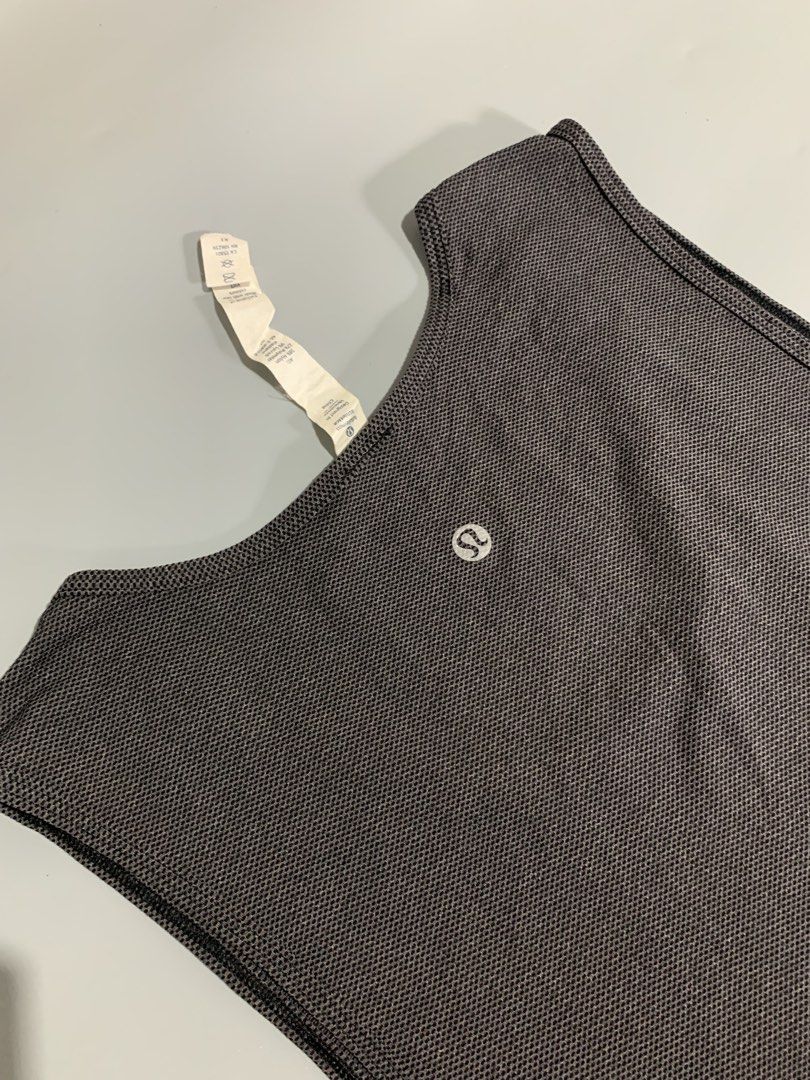 Lululemon Athletic Tank Top Size M Grey (Category: Activewear) located in Cebu City. Submitted by stuff_paid (Listing ID 1468639560, Image 3). Description: - Brand: Lululemon - Style: Sleeveless athletic pullover tank top - Color: Grey - Size: M - Material: High-performance blend (Nylon, Polyester, Lycra Elastane, and X-Static Nylon) - Details: Classic reflective Lululemon logo printed on the upper back - Condition: Clean fabric texture, excellen