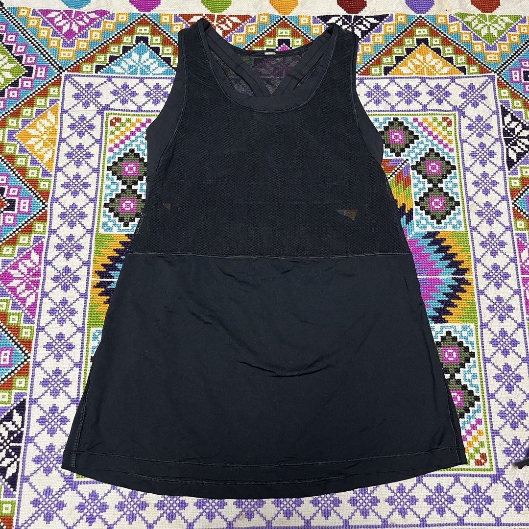 Lululemon Black Mesh Active Tank Top (Category: Activewear) located in Dagupan City. Submitted by vernzkee (Listing ID 1468525028, Image 1). Description: - Brand: Lululemon - Color: Solid Black - Features: Built-in shelf bra for added support - Design: Sheer mesh upper torso and back, racerback with crossed straps - Details: Signature omega logo printed near the bottom hem - Fabric: Lightweight and breathable, ideal for workouts - Condition: Exce