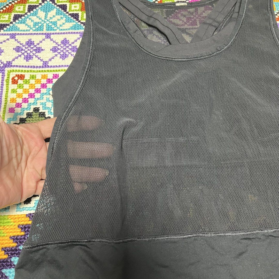 Lululemon Black Mesh Active Tank Top (Category: Activewear) located in Dagupan City. Submitted by vernzkee (Listing ID 1468525028, Image 2). Description: - Brand: Lululemon - Color: Solid Black - Features: Built-in shelf bra for added support - Design: Sheer mesh upper torso and back, racerback with crossed straps - Details: Signature omega logo printed near the bottom hem - Fabric: Lightweight and breathable, ideal for workouts - Condition: Exce