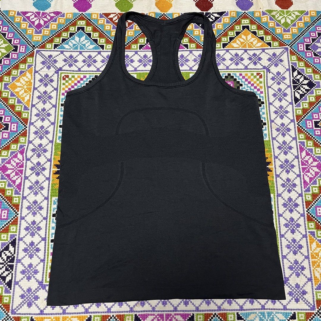 Lululemon Black Racerback Tank Top (Category: Activewear) located in Dagupan City. Submitted by vernzkee (Listing ID 1468525148, Image 1). Description: - Authentic Lululemon racerback tank top in classic black - Seamless, stretchy fabric for ultimate workout comfort - Stylish knit texture patterns along the back and sides - Signature reflective Lululemon logo on the upper back for visibility - Size indicator visible on the inside hem - Ideal for 