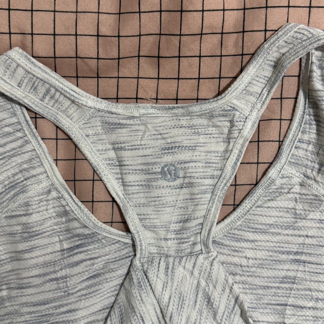 Lululemon grey heathered racerback tank top 🤍 (Category: Activewear) located in Pasay City. Submitted by bellita_05 (Listing ID 1468668270, Image 3). Description: • Colour: Light grey/white heathered • Style: Racerback athletic tank • Logo visible • Size: Tag cut • Measurements: Width 35 cm | Length 20 in • Pre-loved condition Perfect for gym, yoga, pilates, or everyday athleisure wear!.