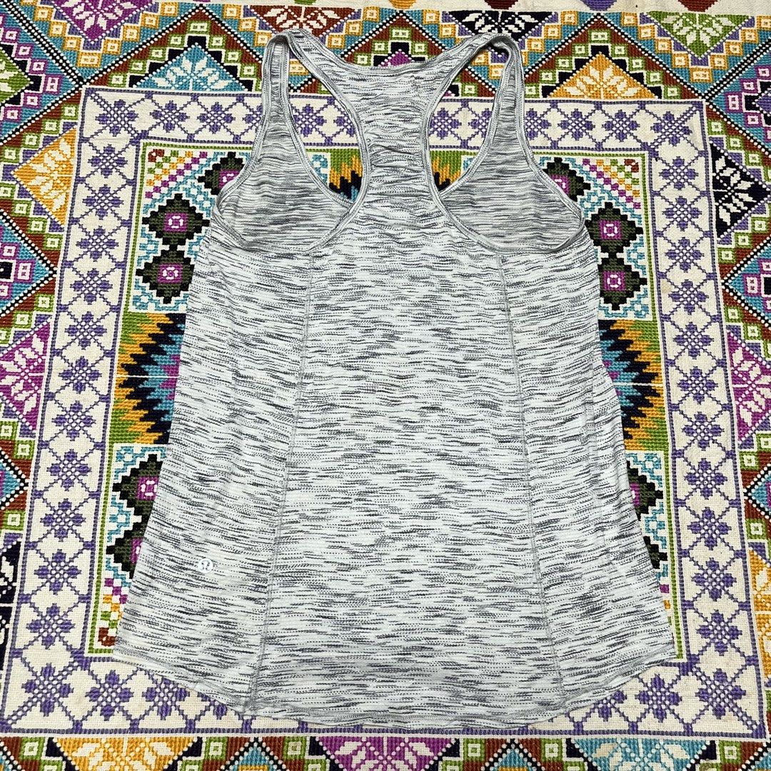 Lululemon Grey Space Dye Racerback Tank Top (Category: Activewear) located in Dagupan City. Submitted by vernzkee (Listing ID 1468524191, Image 3). Description: - Brand: Lululemon - Design: Grey & black space dye print - Style: Racerback with gathered back detail - Hem: Curved, slightly longer in the back - Logo: Iconic omega logo on lower left hem - Fabric: Lightweight, breathable, and sweat-wicking - Condition: Excellent pre-loved condition - P