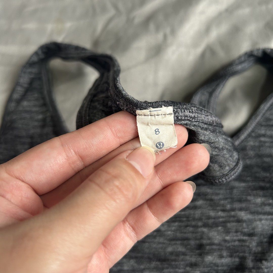 Lululemon Grey Workout Tank Top✨ GANDA AND QUALITYYY (Category: Activewear) located in Baguio. Submitted by especiallyjeans04 (Listing ID 1468660871, Image 3). Description: - Brand: Lululemon - Size: 8 - Color: Grey Marled - Design: Racerback with stylish draped criss-cross back detail - Logo: Iconic silver omega logo on upper back - Material: Soft, breathable athletic fabric - Condition: Excellent / Ready to wear.
