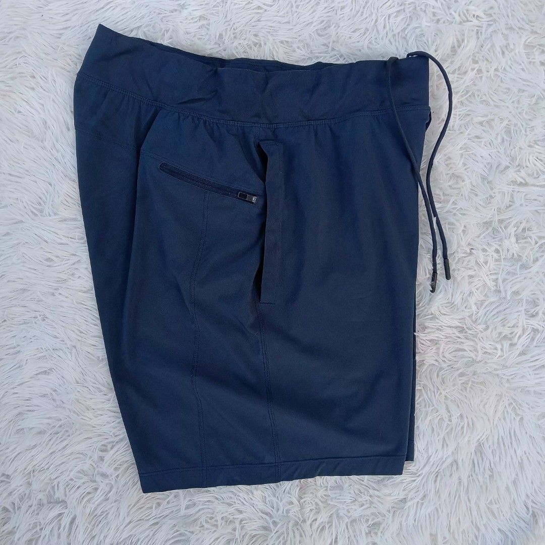 Lululemon Navy Blue Athletic Shorts Size M (Category: Shorts) located in Gattaran. Submitted by thrift_wiseph (Listing ID 1468587973, Image 3). Description: - Brand: Lululemon - Color: Navy Blue - Size: Medium (Tag attached) - Waistband: Elastic with adjustable drawstring and branded metal tips - Storage: Convenient zippered back pocket - Design: Subtle logo near the hem - Material: Lightweight, ideal for workouts or casual wear - Condition: Clea