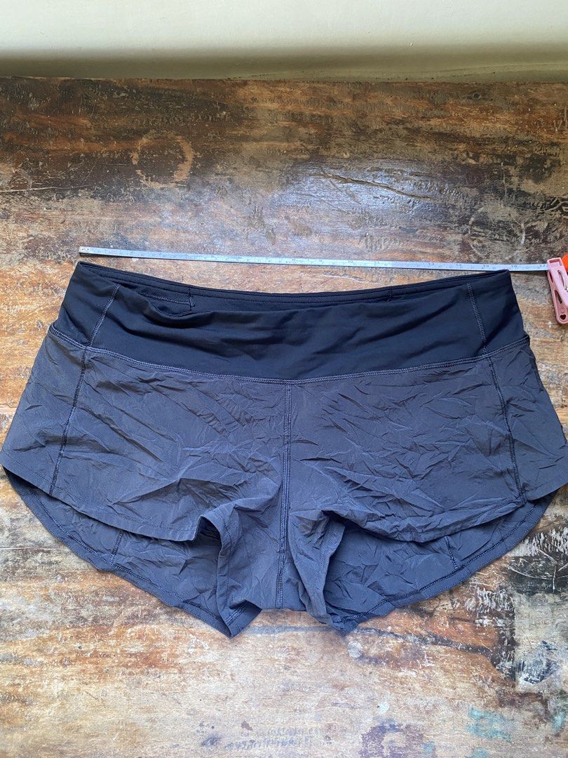 Lululemon Speed Up Shorts Size 8 Medium (Category: Shorts) located in Pulupandan. Submitted by pointyspoon (Listing ID 1468551595, Image 3). Description: - Authentic Lululemon running shorts in dark grey/black - Wide comfortable waistband with a secure back zip pocket - Lightweight technical fabric with a built-in liner - Dual-layer curved hem design for maximum mobility - Reflective logo detail on the left back leg for safety - Exact measurement