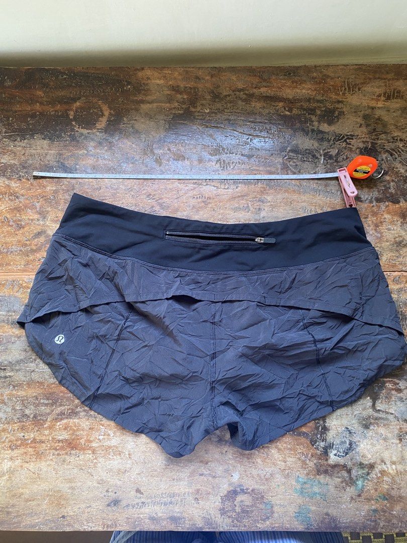 Lululemon Speed Up Shorts Size 8 Medium (Category: Shorts) located in Pulupandan. Submitted by pointyspoon (Listing ID 1468551595, Image 2). Description: - Authentic Lululemon running shorts in dark grey/black - Wide comfortable waistband with a secure back zip pocket - Lightweight technical fabric with a built-in liner - Dual-layer curved hem design for maximum mobility - Reflective logo detail on the left back leg for safety - Exact measurement