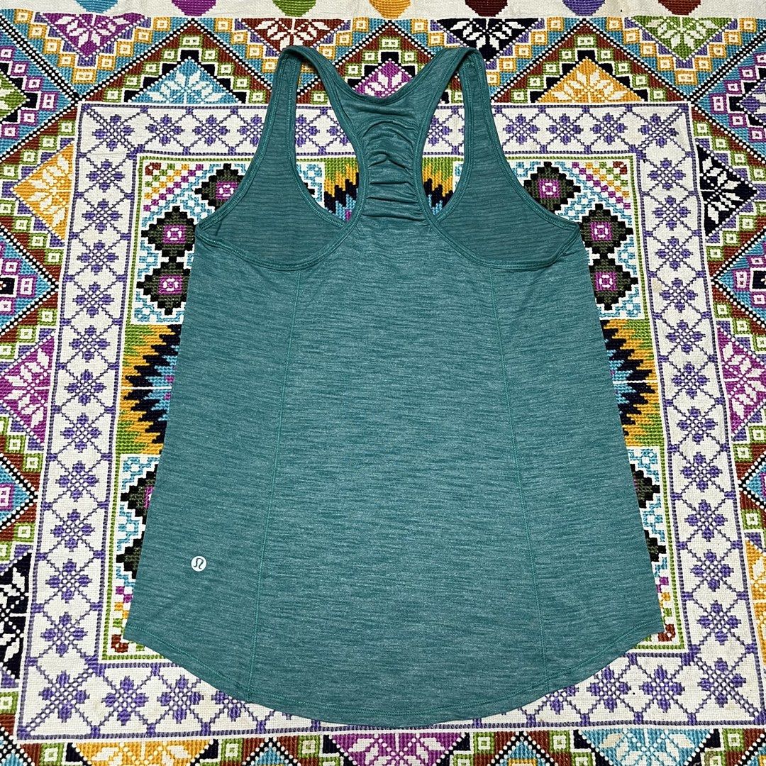 Lululemon Teal Athletic Racerback Tank Top (Category: Activewear) located in Dagupan City. Submitted by vernzkee (Listing ID 1468524083, Image 3). Description: - Brand: Lululemon - Color: Heathered teal green - Style: Racerback with upper back ruching detail - Fit: Flattering curved hemline - Details: Signature reflective omega logo on the lower left hem - Fabric: Breathable, stretchy athletic material Location: Dagupan City, Pangasinan MOP: Gcas