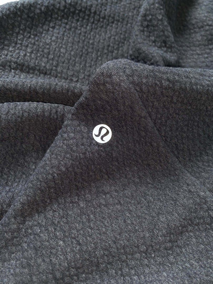 Lululemon Textured Grey Joggers Pants (Category: Joggers) located in Butuan. Submitted by jc13thrifts (Listing ID 1468709151, Image 3). Description: - Brand: Lululemon - Style: Athletic joggers in dark grey - Fabric: Distinctive textured waffle knit - Waistband: Elastic with adjustable black branded drawstring - Pockets: Deep side pockets - Cuffs: Ribbed ankle cuffs - Details: Iconic logo printed near the knee - Condition: Excellent / Like new.