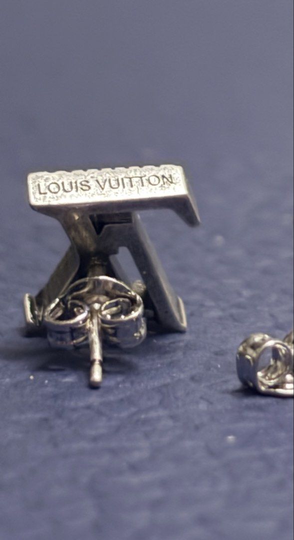 LV Whisper Earrings (Category: Luxury Accessories) located in Imus. Submitted by LUXunBOX (Listing ID 1468655793, Image 2). Description: M03666 LV Whisper Earrings Constructed from versatile sterling silver, the LV Whisper stud earrings brim with nuance and mood. The pairing of a Monogram Flower and a set of LV Initials is rendered in dramatic relief, sculpted and finished with black. This intriguing collection of details enhances daily wear. 1.5