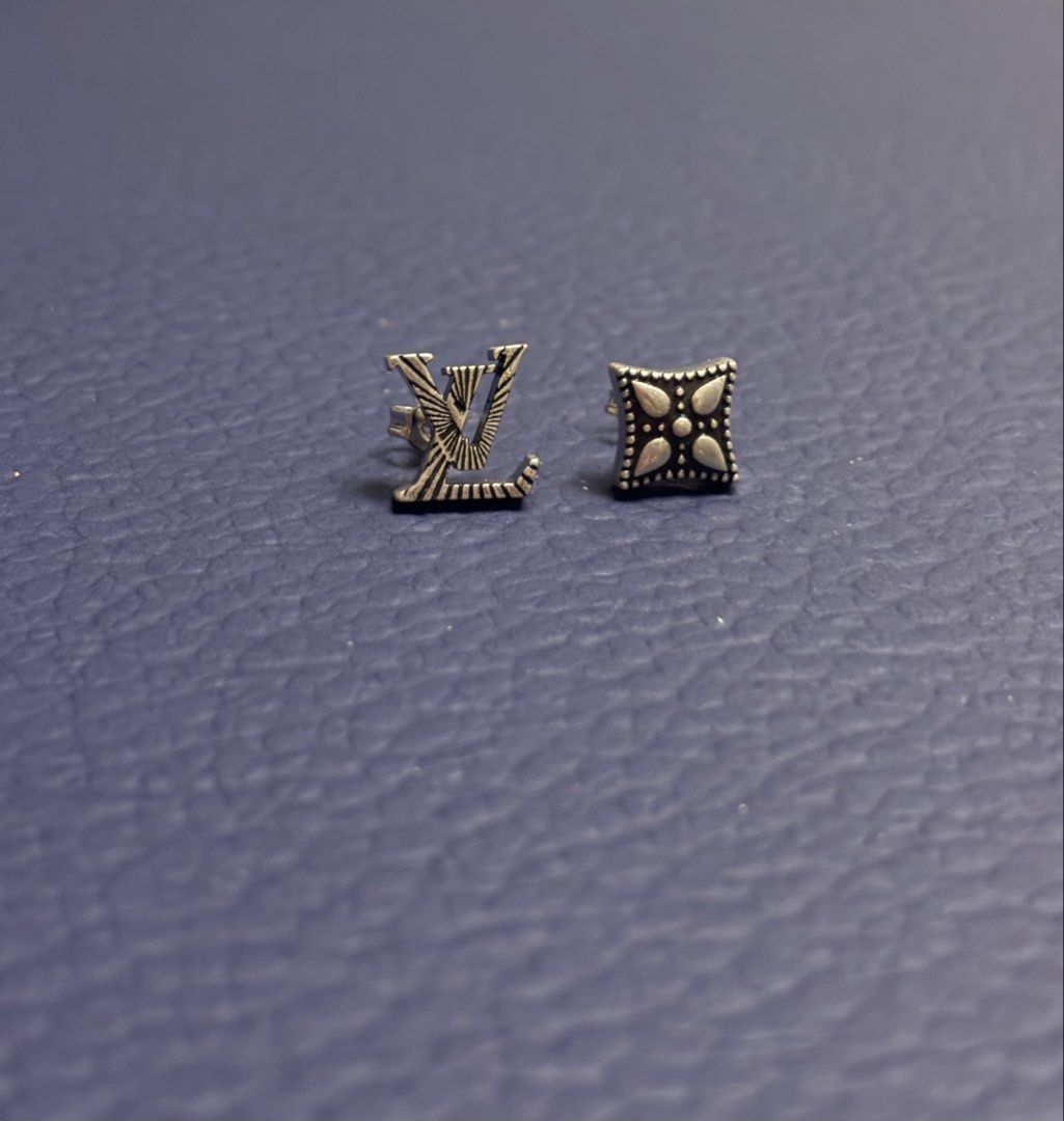 LV Whisper Earrings (Category: Luxury Accessories) located in Imus. Submitted by LUXunBOX (Listing ID 1468655793, Image 1). Description: M03666 LV Whisper Earrings Constructed from versatile sterling silver, the LV Whisper stud earrings brim with nuance and mood. The pairing of a Monogram Flower and a set of LV Initials is rendered in dramatic relief, sculpted and finished with black. This intriguing collection of details enhances daily wear. 1.5