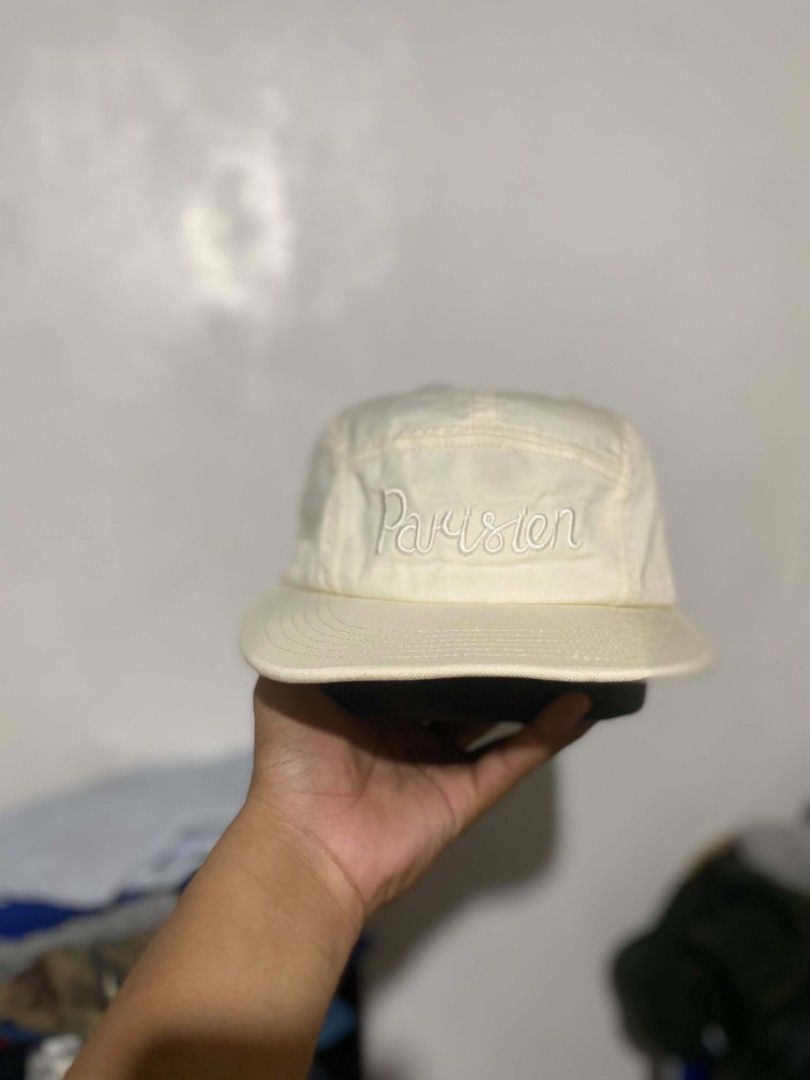 Maison Kitsune Parisien 5P Cap (Category: Caps & Hats) located in Maasin. Submitted by trippythirftyyy (Listing ID 1468646327, Image 1). Description: - Brand: Maison Kitsuné Parisien - Style: 5-panel cap - Color: Off-white / Cream - Material: 100% Cotton - Design: Embroidered Parisien script logo on front crown - Closure: Adjustable back strap with buckle - Condition: Good condition / interior tags intact - Size: Standard adjustable / FREE SIZE.
