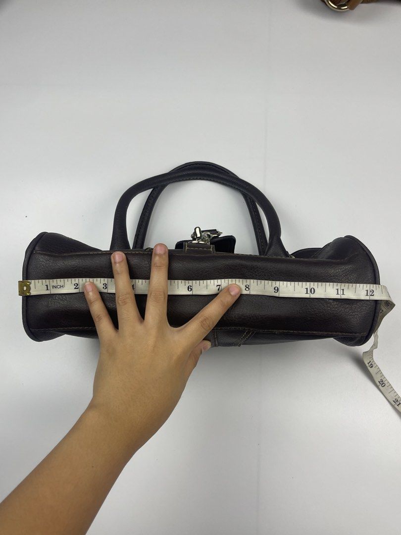 MANGO (MNG) VINTAGE HARDWARE SATCHEL / SHOULDER BAG (Category: Shoulder Bags) located in Cagayan de Oro. Submitted by kmcurations (Listing ID 1468549827, Image 3). Description: MANGO (MNG) VINTAGE HARDWARE SATCHEL / SHOULDER BAG Details & Dimensions: • Material: Grained Faux Leather / Leather-look body in Dark Chocolate Brown with contrast stitching • Interior: Black monogram branded lining with internal zip pocket • Hardware: Silver-tone oversiz
