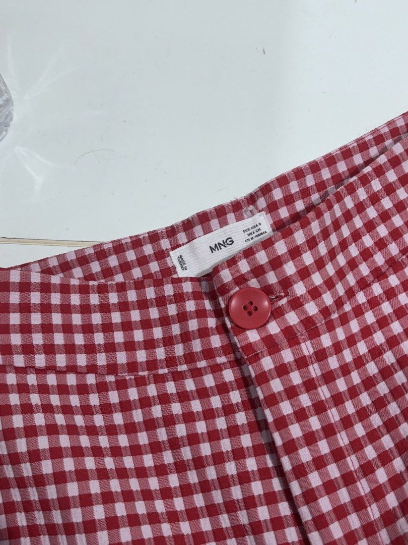 Mango Red and White Gingham Pants Size S (Category: Jeans) located in Manila. Submitted by vintage_wonder8 (Listing ID 1468692209, Image 1). Description: - Brand: Mango (MNG) - Size: S (EUR-USA S, MEX CH, CN M-160/64A) - Pattern: Red and white gingham - Details: Button waist closure, made in Turkey - Condition: Excellent, clean, no flaws - Style: Cute picnic vibe, perfect for casual days out and easy to match with basic tops.