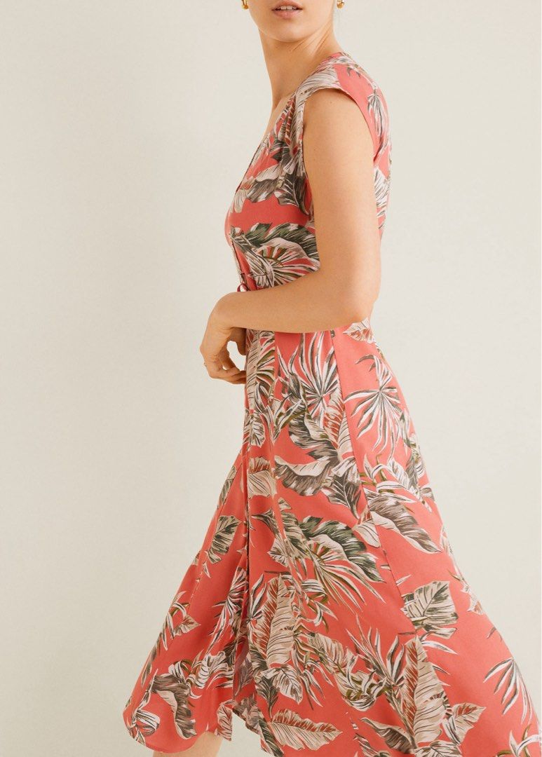 Mango Tropical Midi Dress (Category: Dresses) located in Malolos. Submitted by eadiana (Listing ID 1468574848, Image 2). Description: -flaw‼️: small tear as shown on photo - Brand: MNG Basics - Style: Tropical leaf print midi dress in coral pink with green and white accents - Features: V-neckline, short cap sleeves, button-up front, and adjustable tie-back waist sash - Fabric: Lightweight and cool for warm weather - Origin: Made in Morocco - Cond