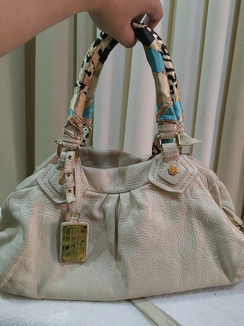 Marc by Marc Jacobs Workwear Leather Handbag (Category: Luxury Bags & Wallets) located in Makati City. Submitted by prelovedtreatedwithlove (Listing ID 1468523528, Image 3). Description: - Brand: Marc by Marc Jacobs Standard Supply - Material: Cream textured leather with gold hardware - Closure: Zipper top with chunky branded pull tab. YKk zip - Straps: Includes a detachable shoulder strap - Condition: Minor scuffs on the metal front plaque from 