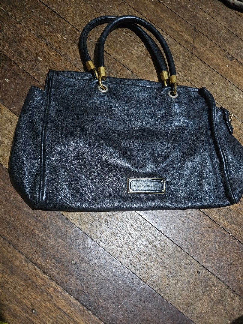 Marc Jacobs MJ Large leather tote bag (Category: Tote Bags) located in Manila. Submitted by onlinesmartshopping12 (Listing ID 1468501763, Image 2). Description: no issues with the leather - Brand: Marc by Marc Jacobs - Material: 100% Cow Leather no issues - Color: Black -large size - Design: Rectangular handbag with dual top handles - Hardware: Gold-tone with some tarnishing - Features: Front flap pocket, zippered interior pocket - Lining: Brande