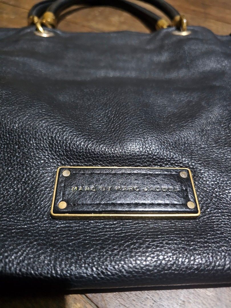 Marc Jacobs MJ Large leather tote bag (Category: Tote Bags) located in Manila. Submitted by onlinesmartshopping12 (Listing ID 1468501763, Image 1). Description: no issues with the leather - Brand: Marc by Marc Jacobs - Material: 100% Cow Leather no issues - Color: Black -large size - Design: Rectangular handbag with dual top handles - Hardware: Gold-tone with some tarnishing - Features: Front flap pocket, zippered interior pocket - Lining: Brande
