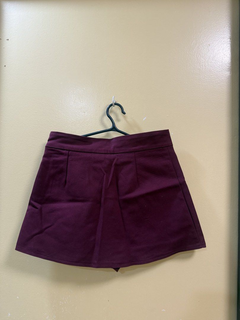 Maroon Asymmetrical Skort Size M (Category: Skirts) located in Makati City. Submitted by shoprory (Listing ID 1468593127, Image 2). Description: - Color: Maroon - Size: Medium (tag inside) - Design: High waist with asymmetrical front slit and pleated back detail - Closure: Side zipper - Versatile piece great for casual outings or dressing up.