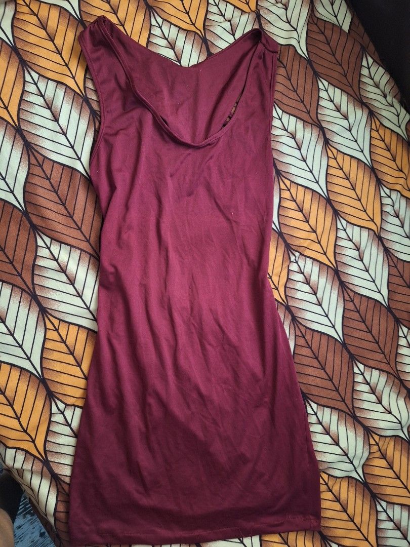 Maroon Bodycon Mini Dress with Strappy Open Back (Category: Dresses) located in Manila. Submitted by bitna44 (Listing ID 1468560362, Image 1). Description: - Color: Deep maroon - Style: Bodycon mini dress with sleeveless front and deep neckline - Back Detail: Stunning cage-style strappy open back - Fit: Super snug fit with stretchy fabric - Length: Mid-thigh - Occasion: Perfect for nights out or parties.