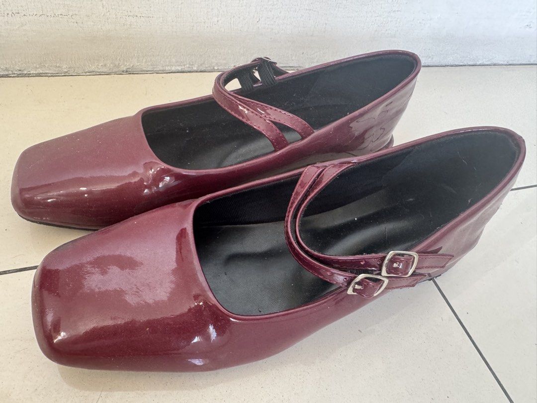 Maroon Mary Jane Patent Heels Double Strap (Category: Heels) located in Manila. Submitted by decluterthings888 (Listing ID 1468579166, Image 1). Description: - Color: Maroon with a glossy patent finish - Design: Trendy square toe with double-strap and silver metal buckles - Comfort: Low block heels and black inner lining - Traction: Durable rubber soles with textured grip - Origin: Made in China stamp on the sole.