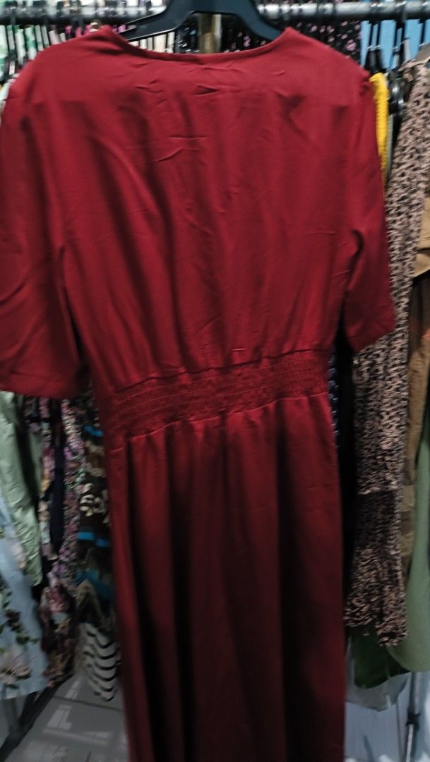 Maroon Maxi Dress Medium (Category: Dresses) located in Quezon City. Submitted by davidclothing (Listing ID 1468517497, Image 2). Description: Red midi dress, size medium. V-neck cut with short sleeves. Button-down front detail leading into a cinched waistline. Back has an elasticated band for easy fit and stretch. Smooth fabric finish. Simple, versatile piece for daily wear or casual outings..