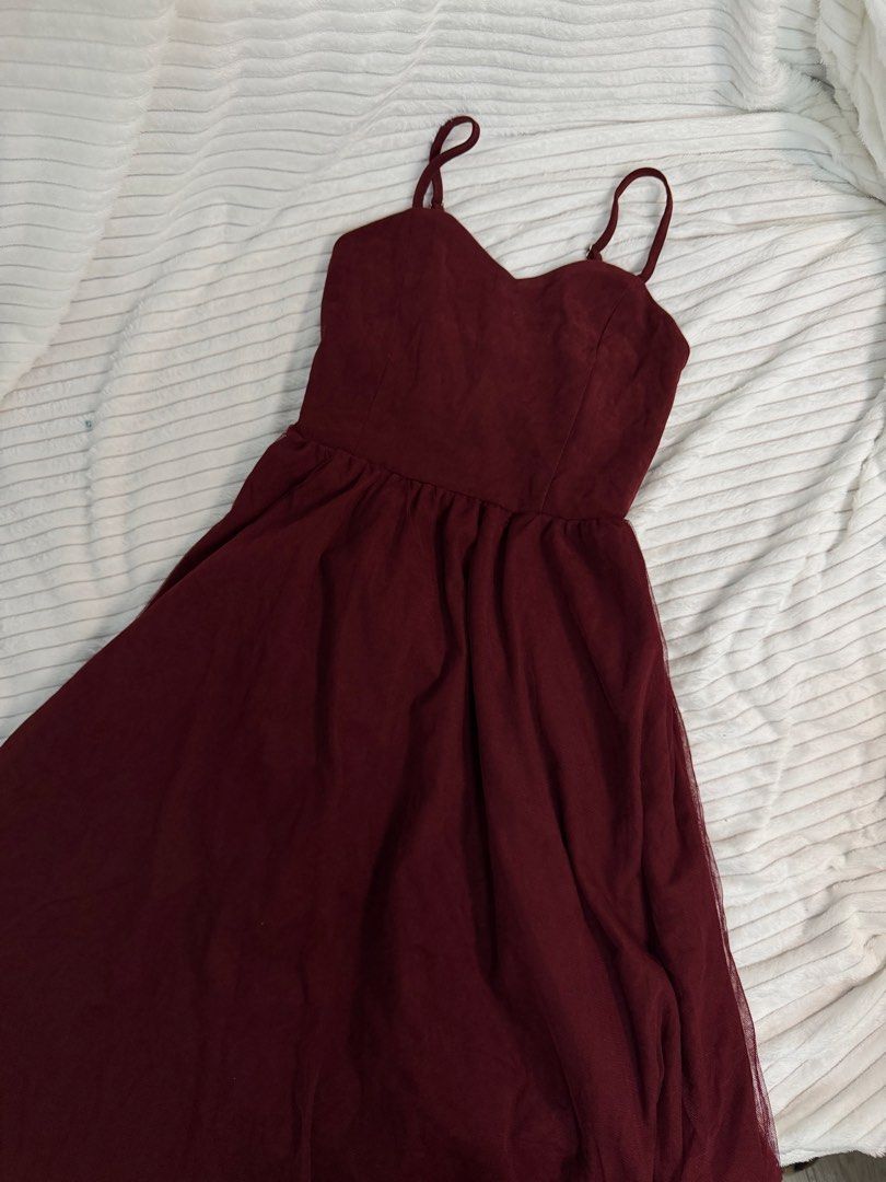 Maroon Spaghetti Strap Tulle Midi Dress (Category: Dresses) located in Rizal. Submitted by kianapreloves (Listing ID 1468593340, Image 1). Description: - Color: Deep maroon - Design: Thin adjustable straps, sweetheart neckline, and fitted waist with gathering details - Skirt: Flared tulle skirt that falls past the knees - Material: Soft textured fabric on top - Closure: Easy back zipper - Condition: Excellent, no stains or loose threads - Best fo