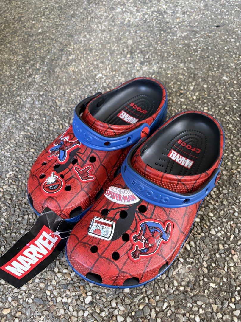 Marvel Spider-Man Crocs size J5 (Brand New) (Category: Babies & Kids Fashion) located in Paranaque City. Submitted by uliman04 (Listing ID 1468517664, Image 1). Description: - Brand: Marvel x Crocs Spider-Man Clogs - Size: Kids J5 - Condition: Brand new, zero tread wear, original Marvel hang tag attached - Design: Red upper with black spider web graphic and blue pivoting heel straps - Features: Includes official Spider-Man Jibbitz charms and blac