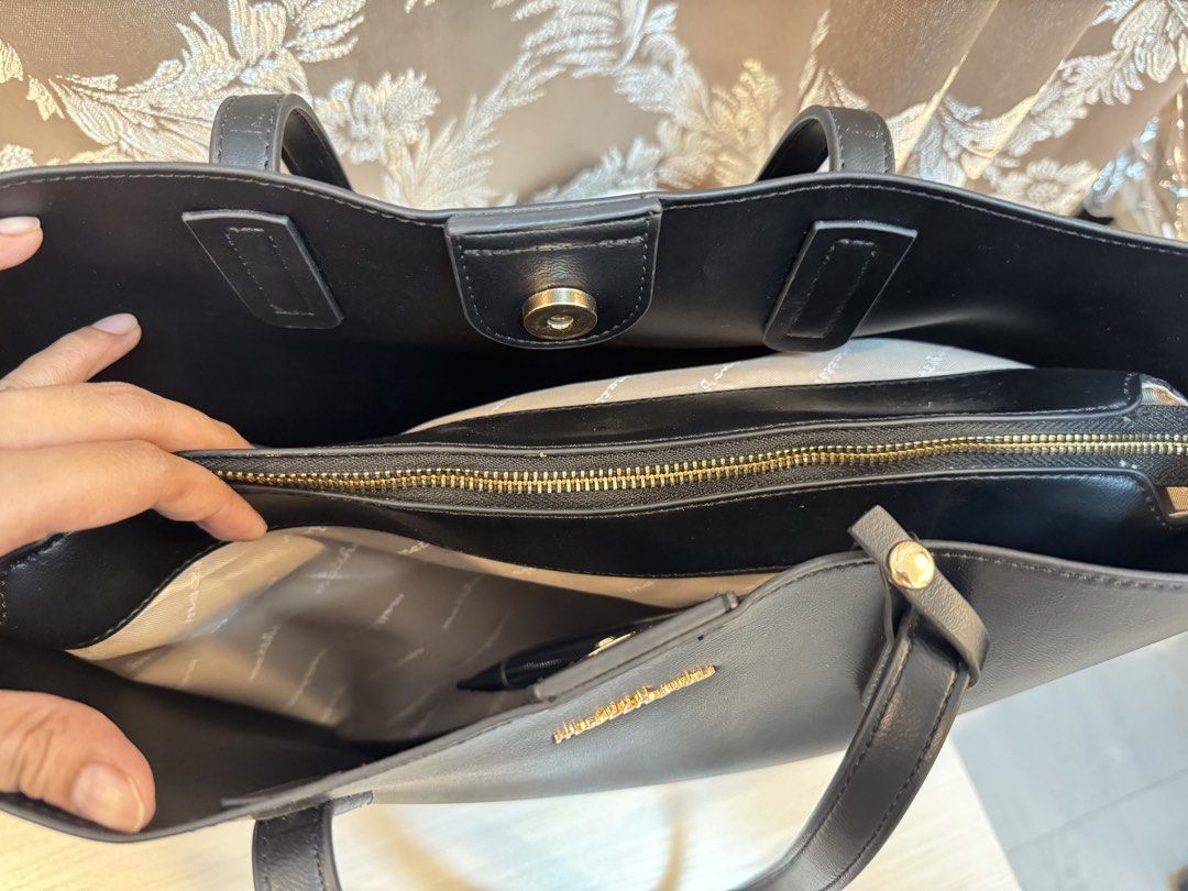 Matthews Black Tote Bag with Pouch (Category: Tote Bags) located in Cavite. Submitted by abiichiix (Listing ID 1468653028, Image 2). Description: w/ dustbag & SM paper bag Used once Can fit 13” laptop/macbook So many black tote bags 📍Cavite - Brand: Matthews - Color: Black with elegant gold-tone lettering - Condition: Brand new with original tag (Original Price: ₱2,499.00) - Closure: Magnetic snap top closure - Interior: Light fabric lining with