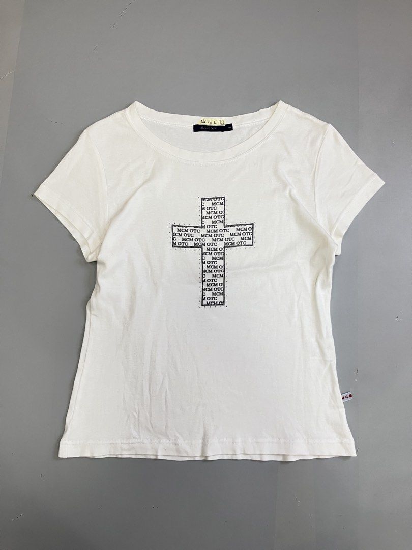 MCM OTC White Rhinestone Cross Tee Size L (Category: Shirts) located in Mabalacat. Submitted by aas_thriftfings (Listing ID 1468573077, Image 1). Description: - Color: White - Design: Rhinestone-studded cross graphic with MCM OTC text patterns - Size: L (includes MCM branded side tags and inner collar tag) - Pit-to-Pit: Approx. 16 inches - Length: Approx. 22 inches - Condition: Good as new, message for inquiries!.
