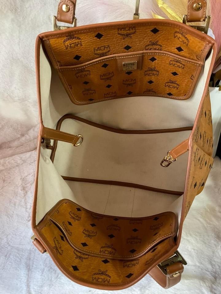 MCM Visetos Monogram Stripe Tote Bag Brown Orange (Category: Luxury Bags & Wallets) located in La Trinidad. Submitted by naravincollections (Listing ID 1468541856, Image 3). Description: - Brand: MCM, Authentic - Style: Visetos Monogram Tote - Design: Classic brown monogram with a vibrant orange and black vertical stripe - Hardware: Gold-tone, in excellent condition, no tarnish - Straps & Trim: Tan leather double shoulder straps *** Recoloring do