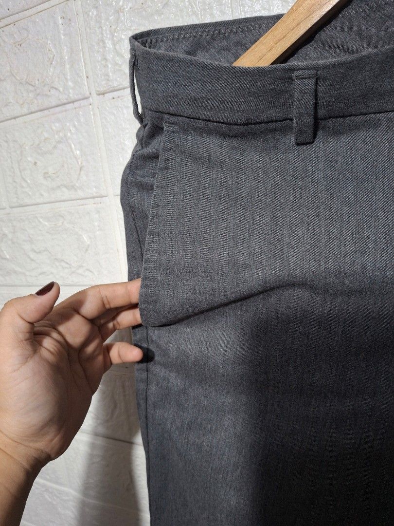 Men's Grey Formal Trousers Slacks (Category: Trousers) located in Angeles City. Submitted by livemountain.e2ae07 (Listing ID 1468527595, Image 3). Description: - Color: Grey - Fit: Slim-fit, mid-rise waist with belt loops - no size on tag - W15.4 L39.4 HEM 6.5 - Closure: Front button and zippered fly - Pockets: Two side slash pockets and two back welt pockets with button closures - Fabric: Clean textured material - Ideal for: Office wear and form