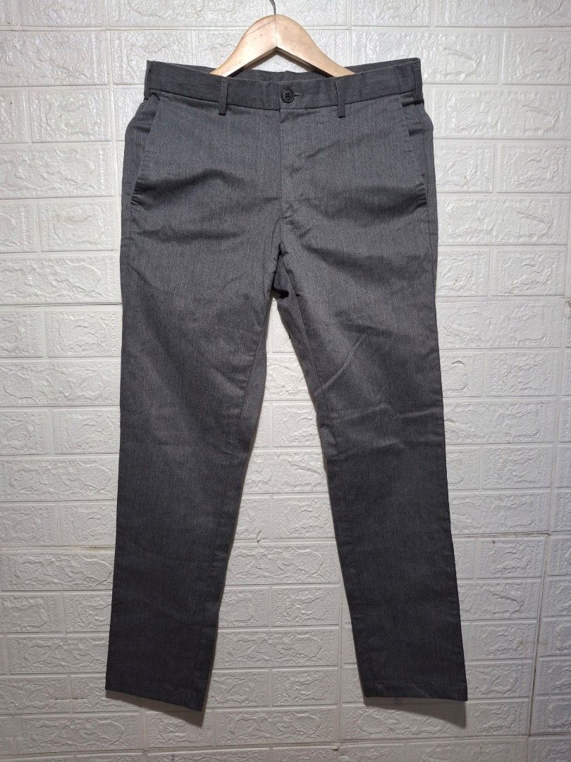 Men's Grey Formal Trousers Slacks (Category: Trousers) located in Angeles City. Submitted by livemountain.e2ae07 (Listing ID 1468527595, Image 1). Description: - Color: Grey - Fit: Slim-fit, mid-rise waist with belt loops - no size on tag - W15.4 L39.4 HEM 6.5 - Closure: Front button and zippered fly - Pockets: Two side slash pockets and two back welt pockets with button closures - Fabric: Clean textured material - Ideal for: Office wear and form