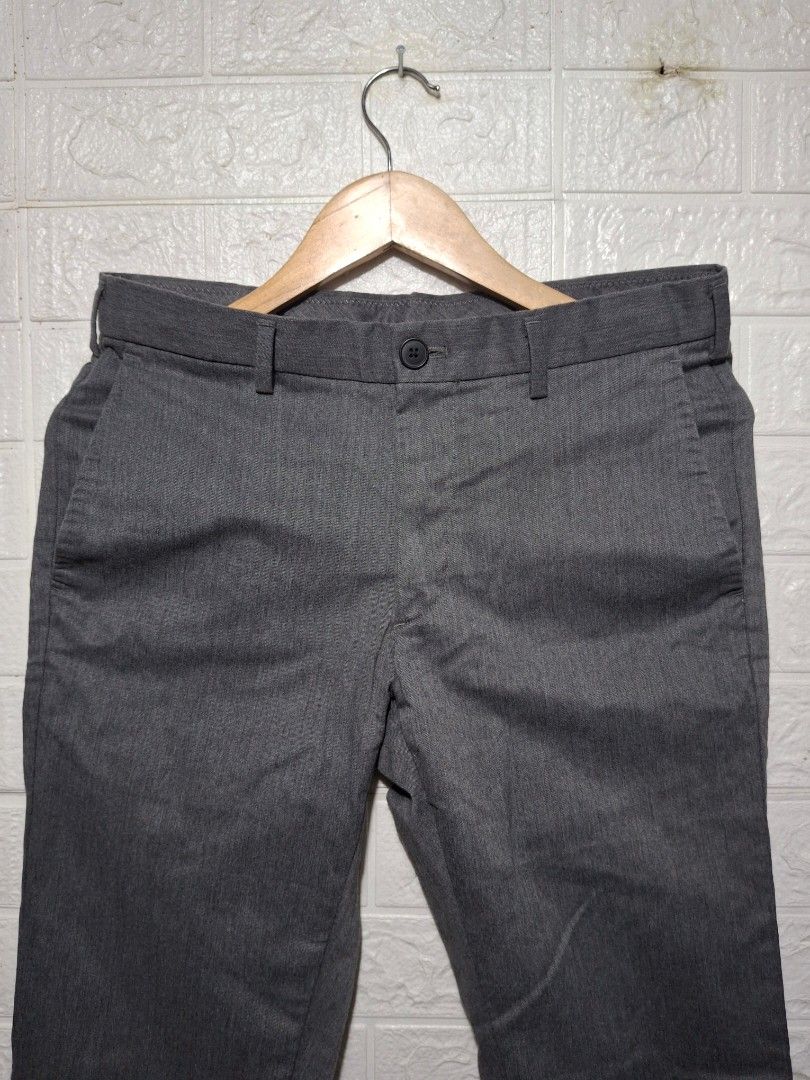 Men's Grey Formal Trousers Slacks (Category: Trousers) located in Angeles City. Submitted by livemountain.e2ae07 (Listing ID 1468527595, Image 2). Description: - Color: Grey - Fit: Slim-fit, mid-rise waist with belt loops - no size on tag - W15.4 L39.4 HEM 6.5 - Closure: Front button and zippered fly - Pockets: Two side slash pockets and two back welt pockets with button closures - Fabric: Clean textured material - Ideal for: Office wear and form