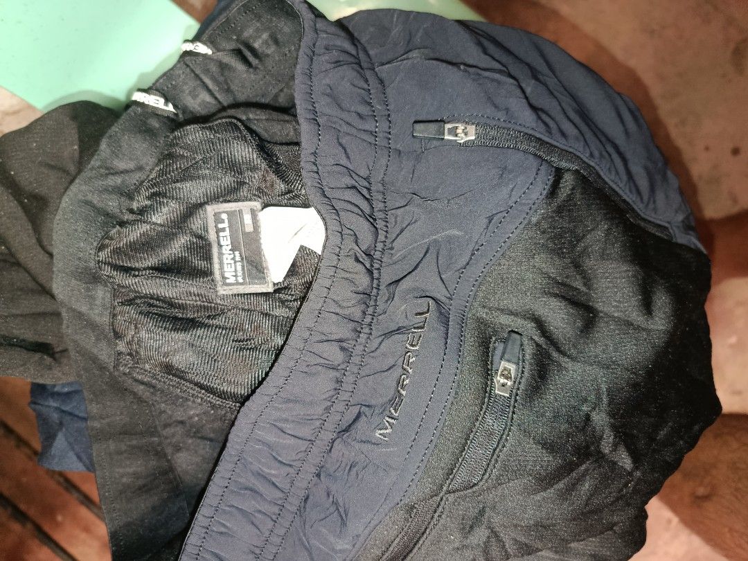 Merrell Black Jogger Pants With Zipper Pockets (Category: Joggers) located in Nabunturan. Submitted by marmitoren42236 (Listing ID 1468509090, Image 2). Description: - Brand: Merrell - Color: Black - Material: Lightweight, breathable athletic fabric with stylish textured panels - Waistband: Comfortable elastic with adjustable drawstring closure - Pockets: Two secure front zipper pockets - Perfect for running, gym workouts, or everyday casual wear