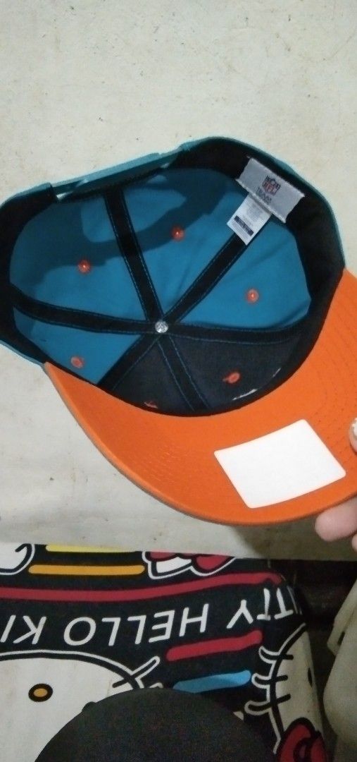 Miami Dolphins NFL Team Headwear Snapback Hat (Category: Caps & Hats) located in Manila. Submitted by tonycess16 (Listing ID 1468526286, Image 3). Description: - Brand: NFL Team Headwear - Team: Miami Dolphins - Condition: Brand new with original tags attached - Colors: Teal crown with orange top button and matching brim underside - Details: Embroidered team logo on front, clean interior taping and stitching - Fit: Adjustable plastic snap closure