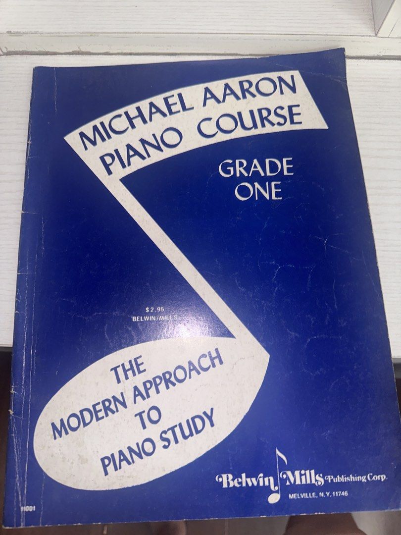 Michael Aaron Piano Course Grade One Book (Category: Textbooks) located in Quezon City. Submitted by chuunic (Listing ID 1468564736, Image 1). Description: - Title: Michael Aaron Piano Course Grade One - Publisher: Belwin Mills Publishing Corp. - Format: Paperback music book, standard size - Condition: Clear interior pages, ideal for beginners - Design: Classic blue cover with white graphic design.