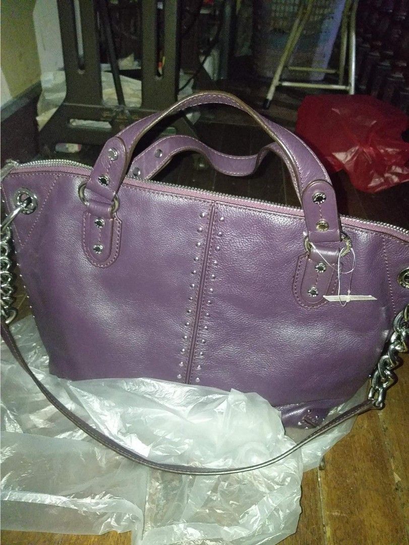 Michael kors crossbody bag (Category: Cross-body Bags) located in Manila. Submitted by onlinesmartshopping12 (Listing ID 1468500595, Image 2). Description: Authentic Michael Kors handbag in a rich purple color. Features silver-tone hardware, including a chain strap and studded accents. Includes a dust bag and Michael Kors shopping bag. The bag has a top zipper closure and a leather tag with the Michael Kors logo inside. The bag has a detachable s
