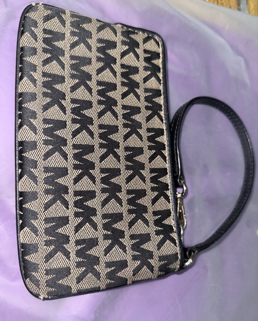 Michael Kors MK Monogram Canvas Wristlet Pouch (Category: Luxury Bags & Wallets) located in Manila. Submitted by ayoltomagotchi (Listing ID 1468594876, Image 3). Description: Michael Kors monogram wristlet in black and beige canvas. Compact zip pouch with a detachable leather strap and silver-tone hardware. Interior features fabric lining with card slots and a slip pocket. Clean inside and out. Great size for carrying cards, cash, and keys..