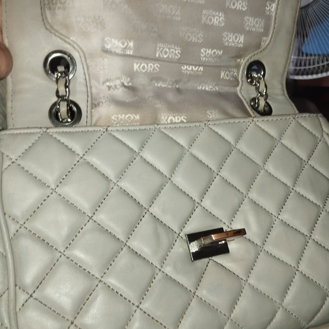 Michael Kors Quilted Leather Shoulder Bag (Category: Cross-body Bags) located in Manila. Submitted by lene48 (Listing ID 1468509043, Image 1). Description: - Brand: Michael Kors - Material: Quilted off-white leather with MK monogram fabric lining - Hardware: Silver-tone chain strap with leather guard and engraved turn-lock closure - Features: Structured flap opening and interior compartments - Condition: Visible wear on the metal lock hardware, w