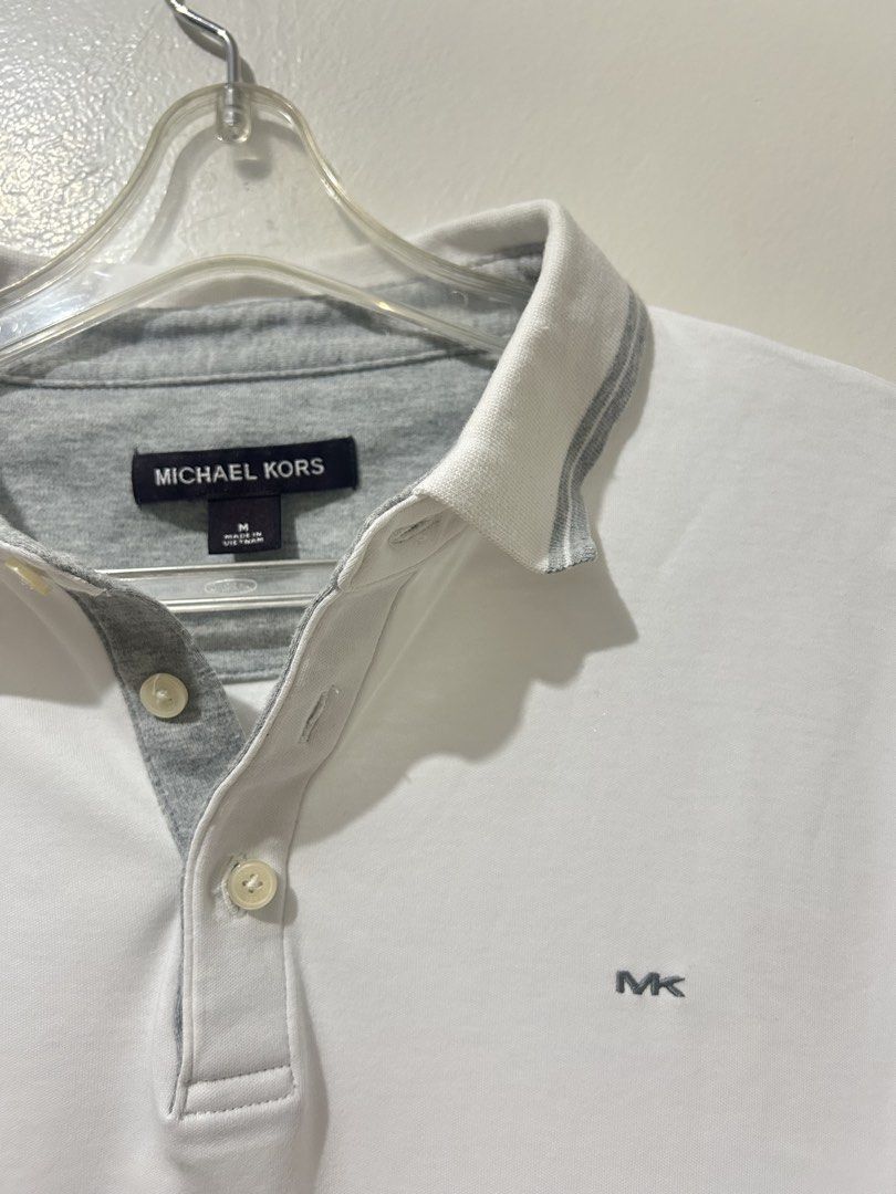 Michael Kors White Polo Shirt (Category: Tshirts & Polo Shirts ) located in Manila. Submitted by timo_clutters18 (Listing ID 1468573579, Image 2). Description: Michael Kors White Polo Shirt Size: M (24x23) Condition: 9/10 *stain on collar MOP: G-Cash/COD Location: Quezon City.